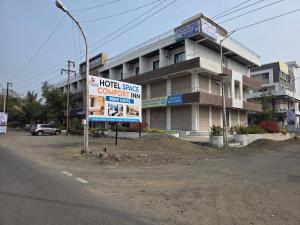 a building with a sign in front of it at Hotel Space Comfort Inn in Karmād
