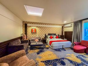 a bedroom with a bed and a couch at Spree Hotel Meerut in Meerut +46 photos