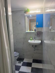 a bathroom with a sink and a toilet at Aloha Inn in Artemida