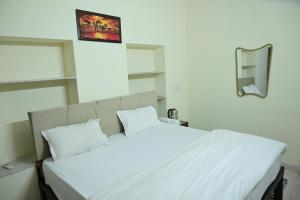 a white bed with two pillows in a bedroom at The Mapple Stay in Jodhpur +7 photos