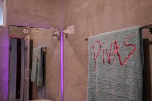 a bathroom with a towel with the word kiss written on it at Divas Hostels in Ahangama +35 photos