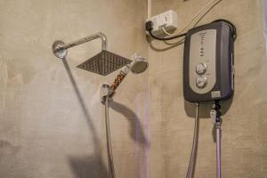 a shower is hooked up to a wall at Divas Hostels in Ahangama