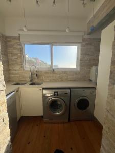 a kitchen with a washing machine and a sink at 8 Muller st Tergniet in Tergniet +15 photos