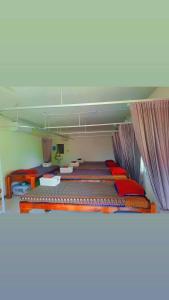 a room with two bunk beds in a room at Mook Phoopha Guest House in Koh Mook +2 photos