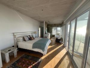 a bedroom with a bed and a balcony at 8 Muller st Tergniet in Tergniet