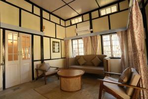 a living room with a couch and a table at Ri Sai Cottage Stays in Nongpoh