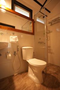 a bathroom with a toilet and a shower at Ri Sai Cottage Stays in Nongpoh +16 photos