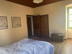 an empty bedroom with a bed and a window at Casetta Teppe rosse in Aléria