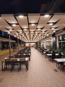 a dining hall with tables and chairs in a building at Dedeman Kemer Resort - Ultra All Inclusive in Kemer