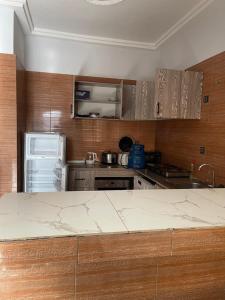 a kitchen with a counter top and a refrigerator at Immeuble do-rego in Lomé