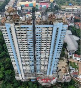 an overhead view of a tall building with a city at Saladin Guest House in Parungmalela