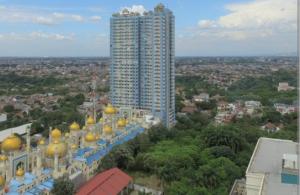 a building with gold domes on it and a tall building at Saladin Guest House in Parungmalela