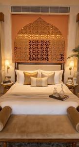 a bedroom with a large bed with a large headboard at Sukoon Gah in Bedla