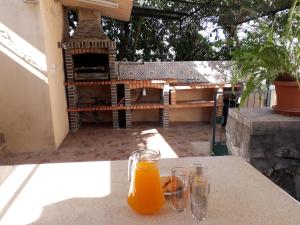 a glass of orange juice sitting on top of a table at Casa dos amigos in Chão de Couce