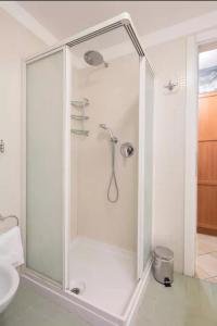a shower with a glass door in a bathroom at Open Space Verona in Verona