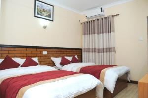 Letto o letti in una camera di Hotel Bagmati