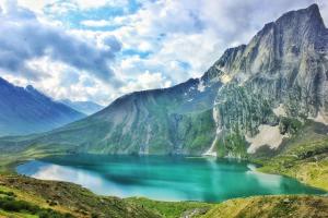 a mountain lake in the middle of a mountain range at Kashmir naaz in Srinagar