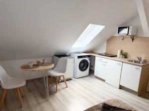 a kitchen with a washing machine and a table at Apartments Brunsbüttel in Brunsbüttel