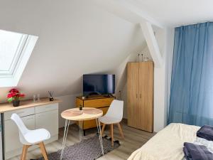 a bedroom with a bed and a table and chairs at Apartments Brunsbüttel in Brunsbüttel