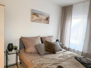 a bedroom with a bed with pillows and a window at Apartments Brunsbüttel in Brunsbüttel
