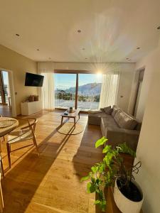 a living room with a couch and a table at Anton's Apartment - Natur & See in Velden am Wörthersee