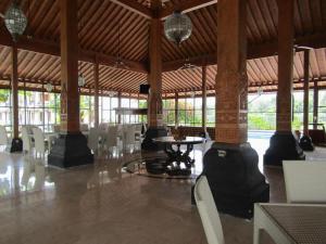a dining area with a table and chairs in a building at AZHIMA Resort and Convention in Adi Sumarmo Wiryokusumo +180 photos