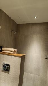 a bathroom with a shower with towels on a counter at Gulmohar527 3BHK Service Apartment Defence Colony in Jāmb +10 photos