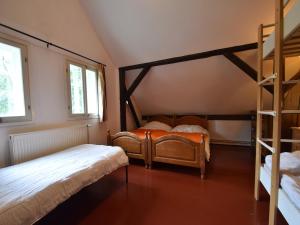 a bedroom with two bunk beds and a ladder at Holiday home in a quiet, authentic mountain village with a view of the surrounding hills in Zlatá Olešnice