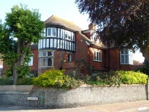 a red brick house with a gambrel at The Manse B&B in Eastbourne