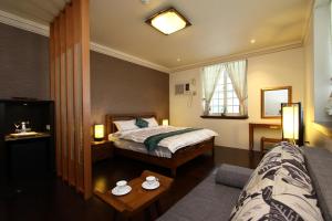 um quarto de hotel com uma cama e uma mesa em Star Shine B&B em Jiaoxi