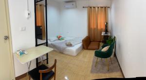 a living room with a bed and a table and chairs at Similan Mondo Resort & Camping in Phangnga