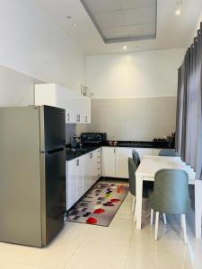 een keuken met een koelkast en een tafel met stoelen bij Farah Boutique Private Villa in Luxor