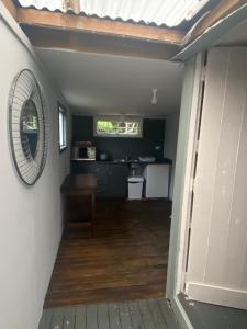 a hallway of a house with a table and a mirror at Wech Cottage in Warkworth
