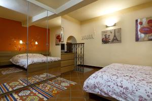 a bedroom with two beds and a glass wall at Camera Dolcenotte in Orta San Giulio