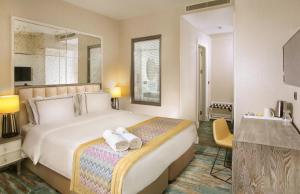 a hotel room with a bed with two towels on it at Berjer Boutique Hotel & Spa in Istanbul
