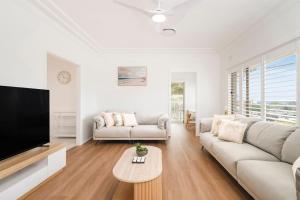 a living room with a couch and a tv at Dalton Escape in Nelson Bay