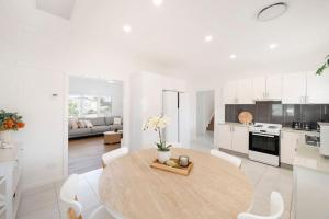 a kitchen and living room with a table and chairs at Dalton Escape in Nelson Bay