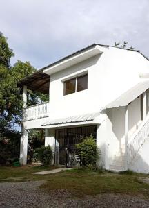 a white house with a large garage at Casa Valentina in Río San Juan