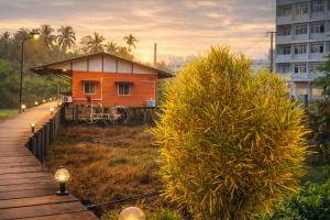 a small house with a pathway leading to it at Similan Mondo Resort & Camping in Phangnga