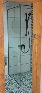 a shower with a faucet in a bathroom at Kajüt Apartman in Balatonfenyves