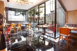 a restaurant with tables and chairs and windows at Berjer Boutique Hotel & Spa in Istanbul