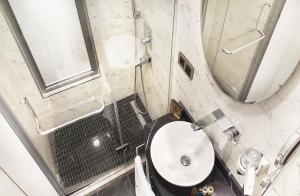 a bathroom with a sink and a toilet and a mirror at Berjer Boutique Hotel & Spa in Istanbul
