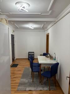 a dining room with a table and blue chairs at Bulevard Residence in Drobeta-Turnu Severin +14 photos