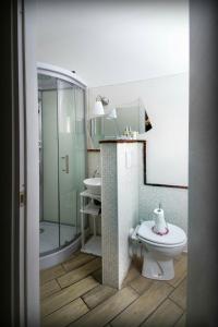 a bathroom with a toilet and a shower and a sink at La Gioia in Camogli