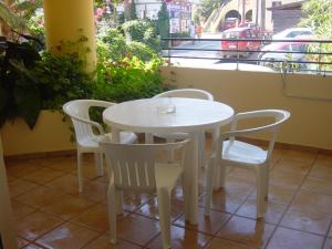 a white table and chairs in front of a window at Marias Studios and Apartments in Plataniás +19 photos