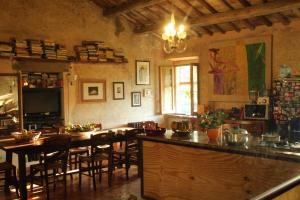 a kitchen with a bar and a table and chairs at La Scaletta in Formello