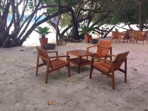 a group of chairs and a table on the beach at MP Resort Koh Phayam in Ko Phayam