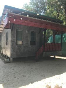a house with a porch and a deck at MP Resort Koh Phayam in Ko Phayam