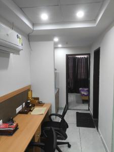 an office with a desk and chairs in a room at Chandigarh city centre in Zirakpur