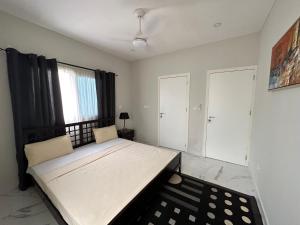 a bedroom with a large bed in a room at Heritage Community in Brufut